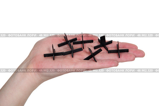 Hand holding tile spacers. Стоковое фото, агентство Ingram Publishing / Фотобанк Лори