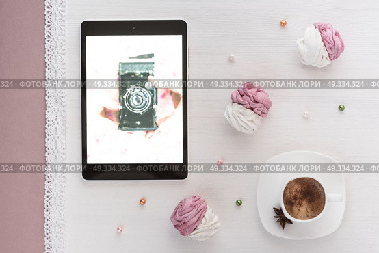 handmade marshmallows next Cup of coffee and a tablet with a picture of the camera. Стоковое фото, агентство Ingram Publishing / Фотобанк Лори