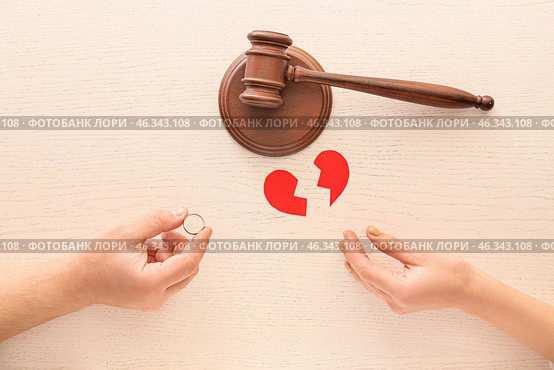 Hands of couple with wedding rings, broken heart and judge's gavel on white background. Concept of divorce. Стоковое фото, фотограф Pixel_shot / Фотобанк Лори