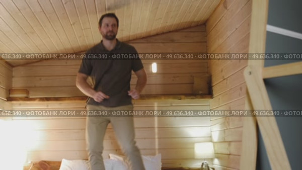 Handsome bearded man dance, have fun at home listens song, moves to music, feels overjoyed, celebrate good news, relish carefree life looks happy. Young adult male twirls, grooves. Brutal man dancer. Стоковое видео, видеограф Марина Демидюк / Фотобанк Лори