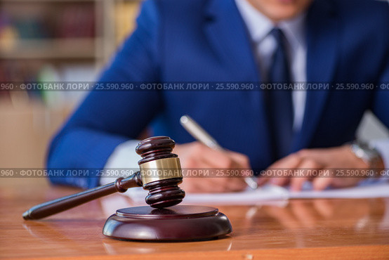 Handsome judge with gavel sitting in courtroom. Стоковое фото, фотограф Elnur / Фотобанк Лори