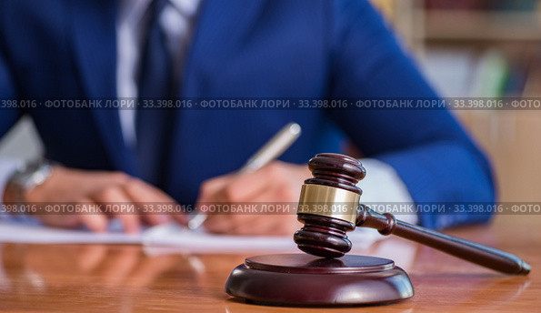 Handsome judge with gavel sitting in courtroom. Стоковое фото, фотограф Elnur / Фотобанк Лори