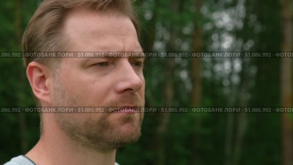 Handsome young man standing outdoors. Male thinking looking around feel happy, calm and serious. Green park background. Guy business employer, businessman manager inspired in nature. Diversity People. Стоковое видео, видеограф Марина Демидюк / Фотобанк Лори