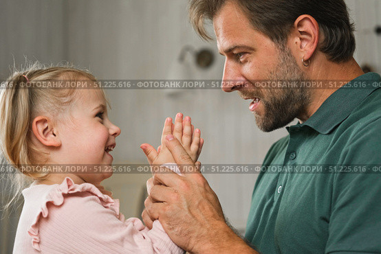 Happy Father Playing with Daughter. Three Years Baby Smiling, Laughing, Looking at Daddy. Man Showing Affection to Child. Candid Real Emotion. Beard Dad and Little Kid Girl. Authentic Family Lifestyle. Стоковое фото, фотограф Марина Демидюк / Фотобанк Лори
