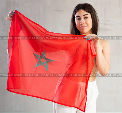 Happy young woman with flag of Monaco against unicoloured background. Стоковое фото, фотограф Яков Филимонов / Фотобанк Лори