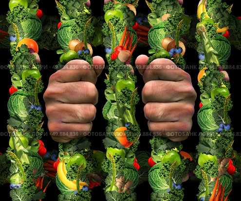 Healthy eating obsession  concept and addicted to health food symbol or or orthorexia nervosa as an extreme eating habit of consuming only certain foods as human hands holding prison bars from a jail cell made of fruits and vegetables. Стоковое фото, агентство Ingram Publishing / Фотобанк Лори