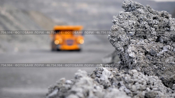 Heavy large transport in mining industry on background of open white multistage quarry. Стоковое фото, фотограф David Kashakhi / Фотобанк Лори