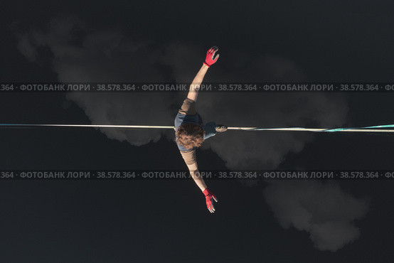Highline over water. The athlete walks on a line above the water. Epic aerial view. Стоковое фото, фотограф Happyphotons / Фотобанк Лори