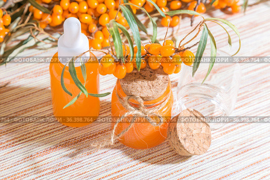 Hippophae homemade sea buckthorn oil in a glass bottle with a pipette on the background with a copy space, alternative herbal medicine and cosmetology. Стоковое фото, фотограф Светлана Евграфова / Фотобанк Лори