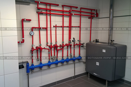 House heating system equipment. Pipelines. Basement mechanical room with condensing water heater, storage tank, plumbing systems. Plumbing service. Pipeline in boiler room. Pipes. Wall installation. Стоковое AI-изображение, AI-художник Марина Демидюк / Фотобанк Лори