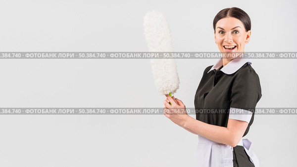housekeeper with happy surprised face duster. Стоковое фото, агентство Ingram Publishing / Фотобанк Лори