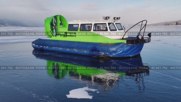 Hovercraft stands on the frozen mirror ice surface of lake baikal and is reflected on the ice surface. khivus, a safe winter vehicle for moving on water or frozen ice. closeup. Стоковое видео, видеограф ЛУНИНА ВЕРОНИКА / Фотобанк Лори