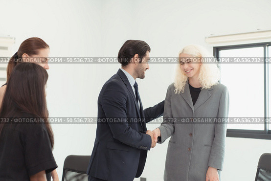 In the company meeting room Young executives are brainstorming ideas about a new business that will launch big soon. Стоковое фото, агентство Ingram Publishing / Фотобанк Лори
