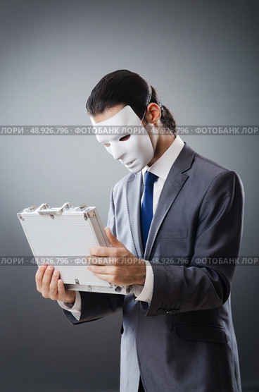 Industrial espionate concept with masked businessman. Стоковое фото, агентство Ingram Publishing / Фотобанк Лори