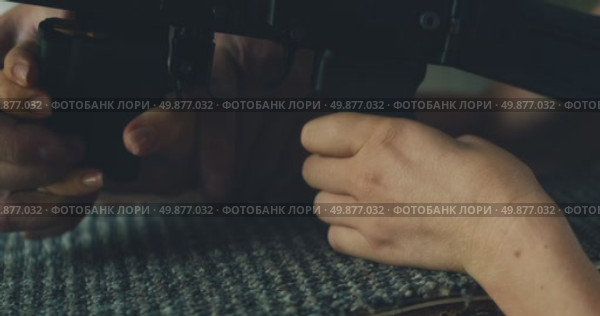 Instructor guides woman hand placement on rifle during shooting lesson outdoors during firearm handling training. Стоковое видео, видеограф Igor Tichonow / Фотобанк Лори