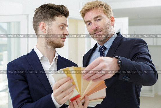 interior designers teamwork with pantone swatch and house building plans. Стоковое фото, агентство Ingram Publishing / Фотобанк Лори