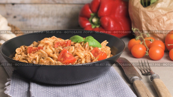 Italian Pasta with Tuna and Basil. Fresh pasta with tuna and tomato sauce on old wooden background. Стоковое фото, агентство Ingram Publishing / Фотобанк Лори