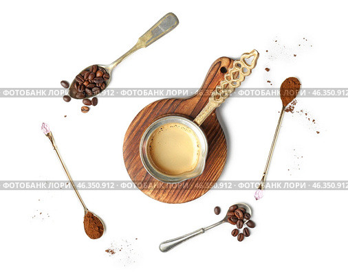 Jezve with hot coffee and spoons on white background. Стоковое фото, фотограф Pixel_shot / Фотобанк Лори