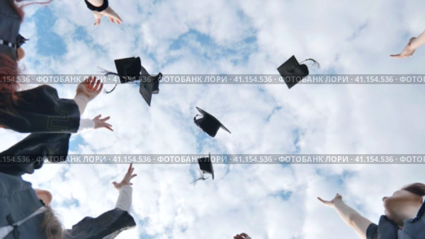 Joyful graduates stand in a circle and toss their caps up. Стоковое видео, видеограф Mikhail Davidovich / Фотобанк Лори