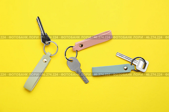 Keys with leather keychains on color background. Стоковое фото, фотограф Pixel_shot / Фотобанк Лори