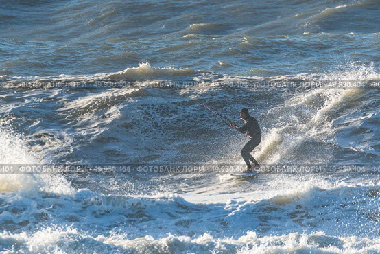 Kiteboarder enjoy surfing on a sunny day. Стоковое фото, агентство Ingram Publishing / Фотобанк Лори