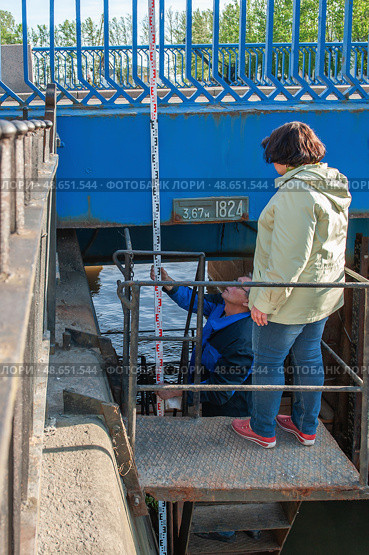 Kronstadt, Russia. June 11, 2015. Surveyors measure sea level. From the zero point of the Kronstadt footpost, measurements of the depth of the Baltic Sea and absolute heights are made throughout Russia. Редакционное фото, фотограф Оксана Медведева / Фотобанк Лори