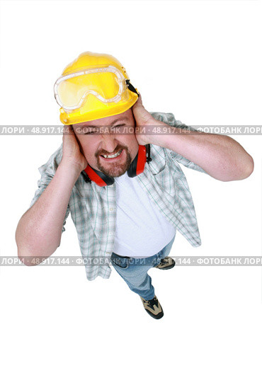 Landscape picture of worker covering his ears. Стоковое фото, агентство Ingram Publishing / Фотобанк Лори