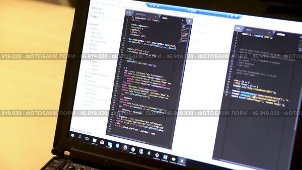 Laptop of programmer with script codes on display. Стоковое фото, фотограф David Kashakhi / Фотобанк Лори