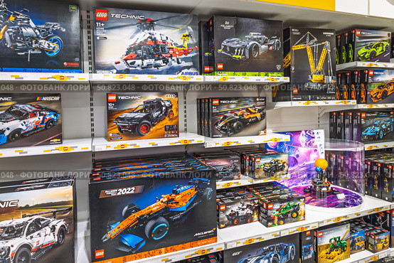 LEGO Technic supercar and racing sets stacked on retail shelf. London, UK, 2 June 2024. Редакционное фото, фотограф Zydrius Tartenis / Фотобанк Лори