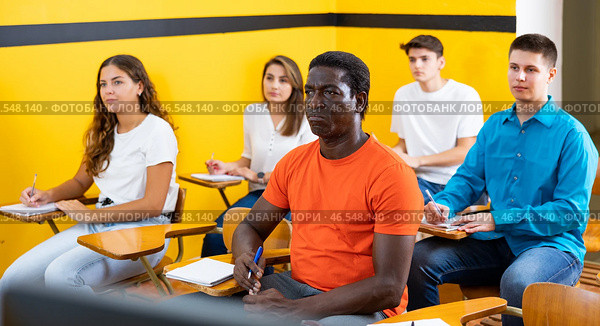 Lesson in the classroom of the driving school - students at their desks and take a theoretical course of work in taxi. Стоковое фото, фотограф Яков Филимонов / Фотобанк Лори