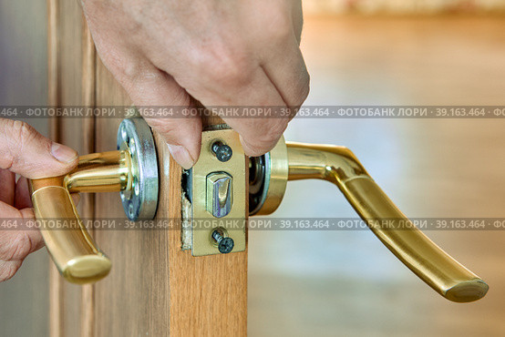 Lever door handle is installed in interior door of house. Стоковое фото, фотограф Владимир Григорьев / Фотобанк Лори