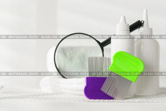 Lice treatment product next to a nit comb and magnifying glass. Стоковое фото, фотограф Сергей Толмачёв / Фотобанк Лори