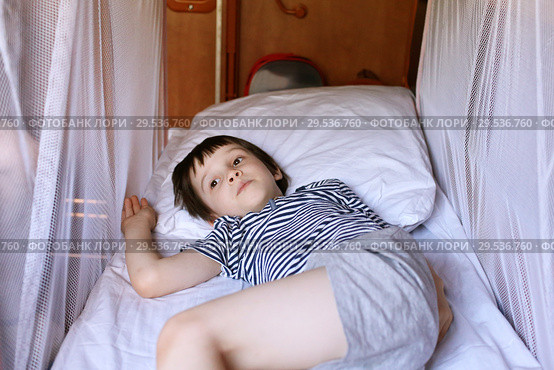 Little boy resting in the  train compartment. Стоковое фото, фотограф ivolodina / Фотобанк Лори