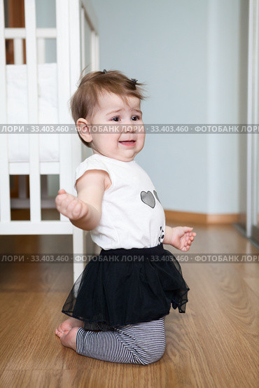 Little capricious child standing on floor of domestic room, screaming and crying. Girl behaves badly. Стоковое фото, фотограф Кекяляйнен Андрей / Фотобанк Лори