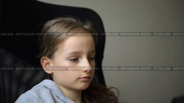 Little sad girl is sitting on black office chair, punishment, serious face. Стоковое видео, видеограф Ольга Балынская / Фотобанк Лори