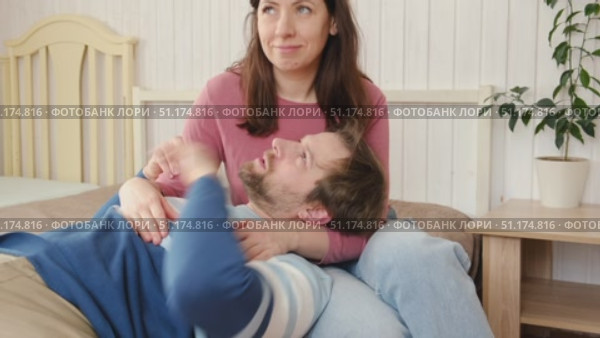 Loving mature couple interactions at home. Man and woman embracing, hugging, holding hands and dancing. Wife with husband intimate moments. couple is touching, cuddling, kissing. Natural lighting. 4K. Стоковое видео, видеограф Марина Демидюк / Фотобанк Лори