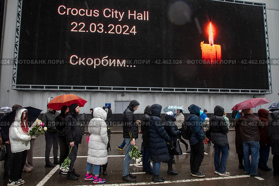Люди стоят в очереди к стихийному мемориалу в память о погибших при теракте у здания концертного зала "Крокус сити холл", Московская область, Россия (2024 год). Редакционное фото, фотограф Николай Винокуров / Фотобанк Лори