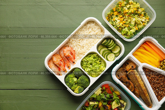 Lunchboxes with tasty healthy food on color wooden background. Стоковое фото, фотограф Pixel_shot / Фотобанк Лори