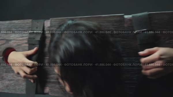 Lust brunette caught in wooden BDSM bench during session. Стоковое видео, видеограф Гурьянов Андрей / Фотобанк Лори