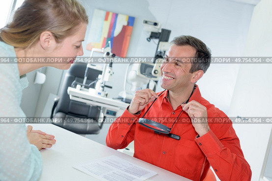 male optometrist talking to female patient in ophthalmology clinic. Стоковое фото, агентство Ingram Publishing / Фотобанк Лори