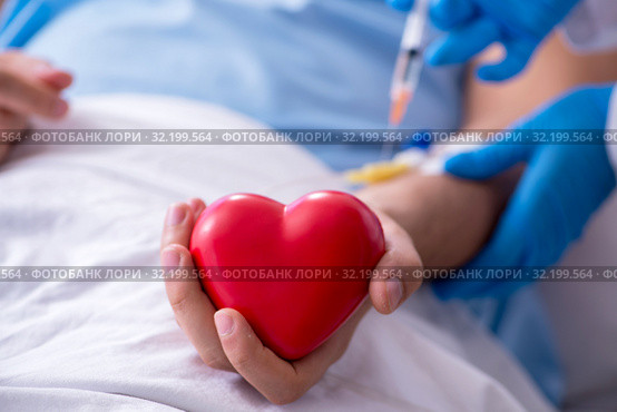 Male patient getting blood transfusion in hospital clinic. Стоковое фото, фотограф Elnur / Фотобанк Лори