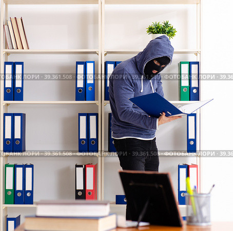 Male thief in balaclava in the office. Стоковое фото, фотограф Elnur / Фотобанк Лори