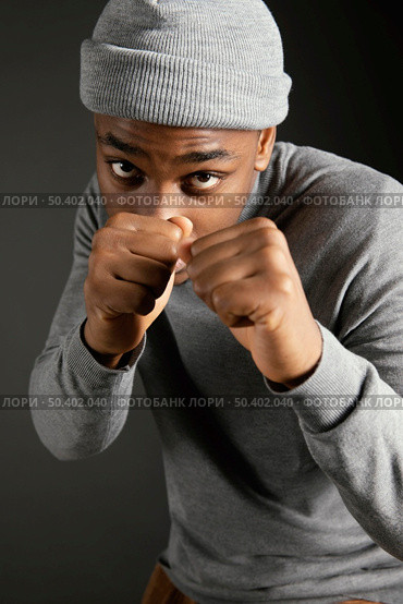 male wearing cap with fists clenched. Стоковое фото, агентство Ingram Publishing / Фотобанк Лори