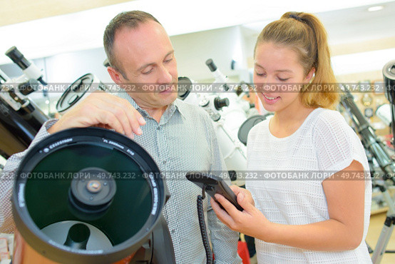 Man and lady looking at professional telescopes. Стоковое фото, агентство Ingram Publishing / Фотобанк Лори