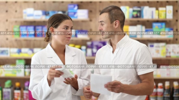 Man client with prescription should contact girl pharmacist for help, takes box remedy. Стоковое видео, видеограф Яков Филимонов / Фотобанк Лори