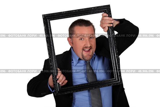 man in coat and tie holding frame. Стоковое фото, агентство Ingram Publishing / Фотобанк Лори