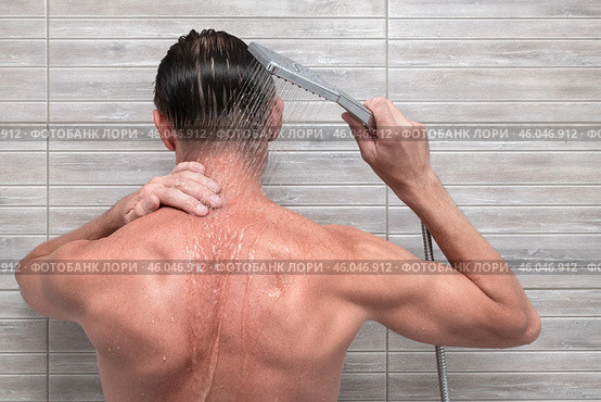 Man in the bathroom under the shower. Taking care of your body. Стоковое фото, фотограф Дмитрий Кобзев / Фотобанк Лори