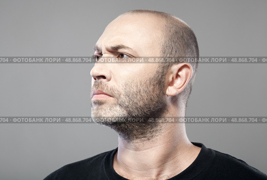 man look into the distance isolated on gray background . Стоковое фото, агентство Ingram Publishing / Фотобанк Лори
