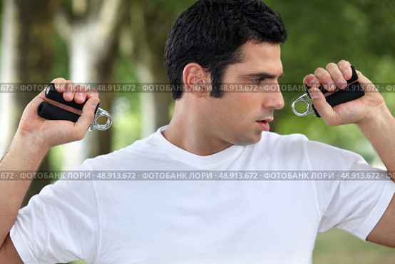 Man performing wrist exercise. Стоковое фото, агентство Ingram Publishing / Фотобанк Лори