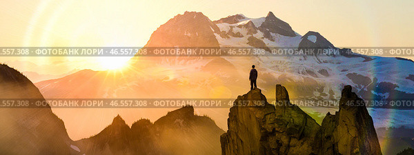 Man standing on mountain peak at sunrise looking at peaks, success motivation goal achievement freedom adventure strength victory inspiration, breathtaking scenery high altitude. Стоковое фото, фотограф Павел Муравьев / Фотобанк Лори